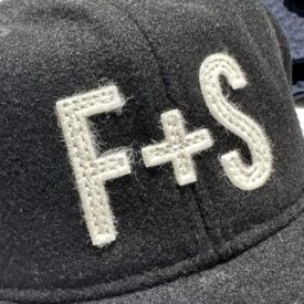 Laser cut wool felt sewn onto the product with different run stitch types. The most common being a bean stitch as seen above. Wool Appliqué provides a vintage ebbets field cap look that gets better with time.